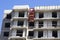 Construction of the building. Unfinished windows. The roof of a high-rise building. Bare brick block