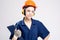 Construction Concepts. Young Smiling Caucasian Female Works Manager With Drawing Paper Notepad Posing in Coverall and Hard Hat