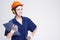 Construction Concepts. Young Smiling Caucasian Female Works Manager With Drawing Paper Notepad Posing in Coverall and Hard Hat