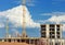 Construction of concrete buildings on background moving clouds i