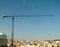 Construction crane above the city. Barcelona, Spain.