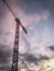 Construction crane, blue, pink, yellow sky