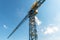 Construction crane on the blue sky background