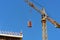 Construction crane with cargo on the background blue sky