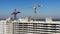 Construction crane on the construction site vertical flying over down to top aerial view