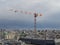 Construction crane high in the sky of Paris. Aerial view of the rooftops