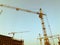 Construction crane, metal for heavy loads stands at a construction site. carrying heavy materials. construction of houses and a