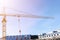 Construction crane tower on blue sky background. Crane and building working progress. Worker. Empty Space for text. Construction c