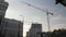 Construction crane is working. Development of new business residential complex with buildings. High tower crane. Real estate. Heav