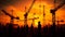 Construction cranes and workers silhouettes in orange sky sunset. Generative AI
