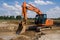 A Construction Crew Operating a Backhoe to Excavate Soil in a Construction Site