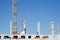 Construction crew working in the summer on the construction of a brick multi-storey building against the blue sky and clouds,