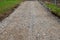 Construction debris recycled from demolished houses is poured into the prepared excavation by trucks and spreaders. a new path is