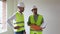 Construction engineer discussing with architect worker at indoor building site