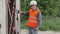 Construction Engineer near building filmed with tablet PC