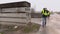 Construction engineer with professional photo camera talking on cell phone