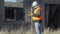 Construction engineer with tablet PC near destroyed building