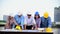 Construction engineer teamwork safety suit trust team holding white yellow safety hard hat security equipment on construction site