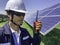 Construction engineers use a walkie-talkie to communicate with technicians in solar power plants