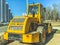 Construction equipment yellow. excavator for construction, sand transfer. houses are being built in the city center, workers are