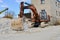 Construction excavator at an industrial gypsum stone processing plant. Crane. Mineral loading. Industrial tourism. Industrial