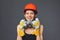 Construction girl in orange hard hat and protective construction mask
