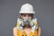 Construction girl in a white hard hat and protective construction mask, for heavy work where you need protection from inhaling
