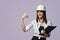 Construction girl in a white helmet, holding a folder. the concept of a business woman who understands construction, repair and