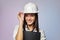 Construction girl in a white helmet, holding a folder. the concept of a business woman who understands construction, repair and