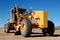 Construction grader on dirt road