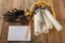 Construction helmet and roll of parchment with design. Construction engineer accessories on a wooden table