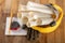 Construction helmet and roll of parchment with design. Construction engineer accessories on a wooden table