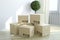 Construction industry, housing, habitation and real estate business concept: group of stacked cardboard boxes on wooden laminated