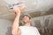 Construction industry worker with tools plastering walls and renovating house in construction site