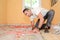 Construction industry worker with tools renovating house with floor tiles in construction site