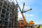 Construction and installation work with a powerful construction crane of a large new industrial oil refining petrochemical