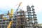 Construction and installation work with a powerful construction crane of a large new industrial oil refining petrochemical