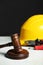 Construction and land law concepts. Gavel, hard hat and different tools on white table