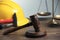 Construction and land law concepts. Gavel, scales of justice, hard hat, pliers and hammer on wooden table, closeup