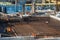 Construction of a large multi-storey commercial building. Builders work in overalls on the site pouring cement and concrete