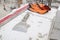 construction level, spatula and orange gloves are on the foam blocks on the construction of a country cottage