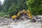 Construction machinery clears stone collapse in the mountains