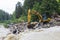 Construction machinery clears stone collapse in the mountains