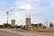 Construction machinery and Equipment on road work. Excavator and tractor on earthmoving at construction site. Tower cranes in