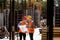 Construction manager and engineer dressed in orange work vests and hard helmets explore construction documentation on