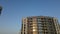 Construction of modern multi-storey buildings. The setting sun is reflected in the windows of the houses. Aerial photography