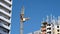 Construction of a multi-storey buildings. Construction crane turns against the sky.