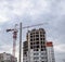 construction of multi-storey residential buildings. Tower cranes at a construction site