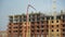 The construction of a multistory apartment building. 4K. Construction workers are pouring concrete floors, construction