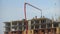 The construction of a multistory apartment building. 4K. Construction workers are pouring concrete floors, construction